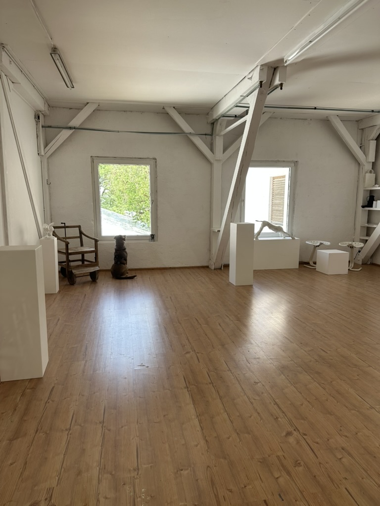 Studio before moving in — bright room with sculptures on plinths